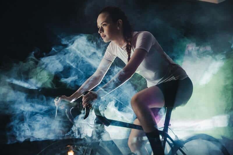 Female Bike Rider In Action Shot With Smoke