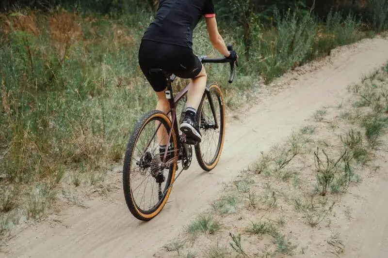 Man In Black Clothing Riding Gravel Bike