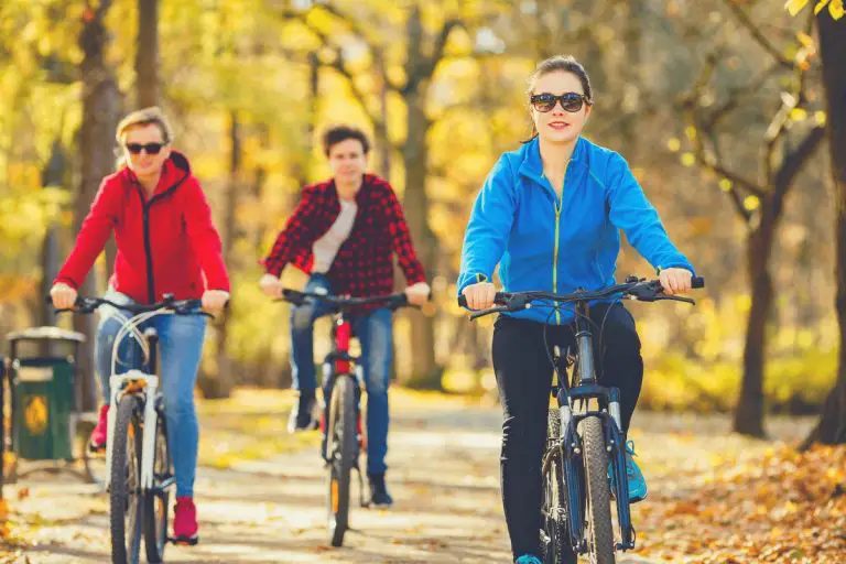 Healthy lifestyle - people riding bicycles in city park