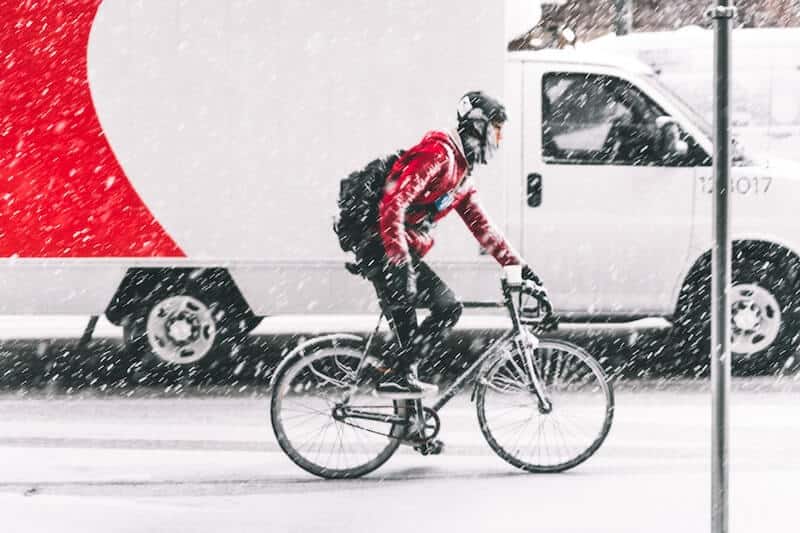 Man Cycling In Heavy Snow