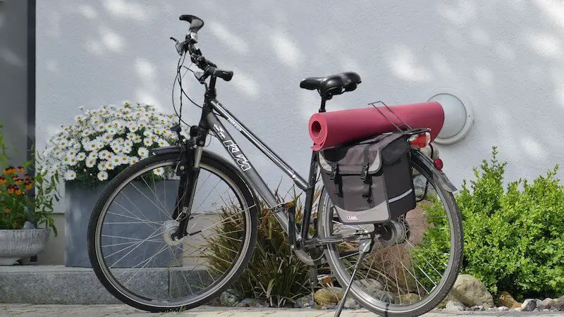 Convertible pannier backpack with yoga mat on bike rack