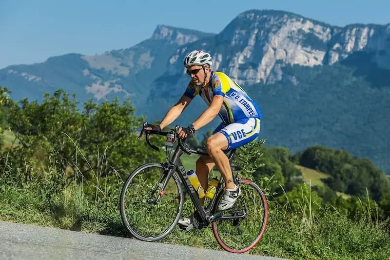 Man Cycling Up Hill on a road bike