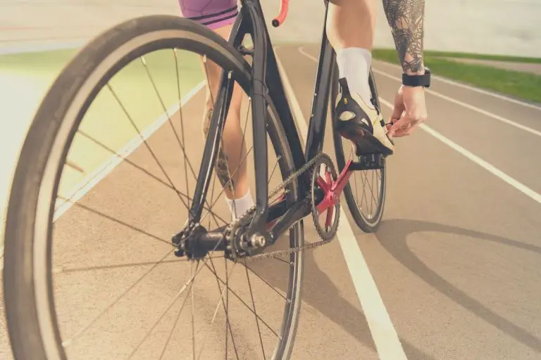 Cyclist Tightening Cycling Shoes Whilst Clipped Into Pedals