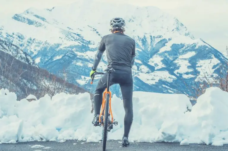 Cyclist Standing In The Snow With Helmet On