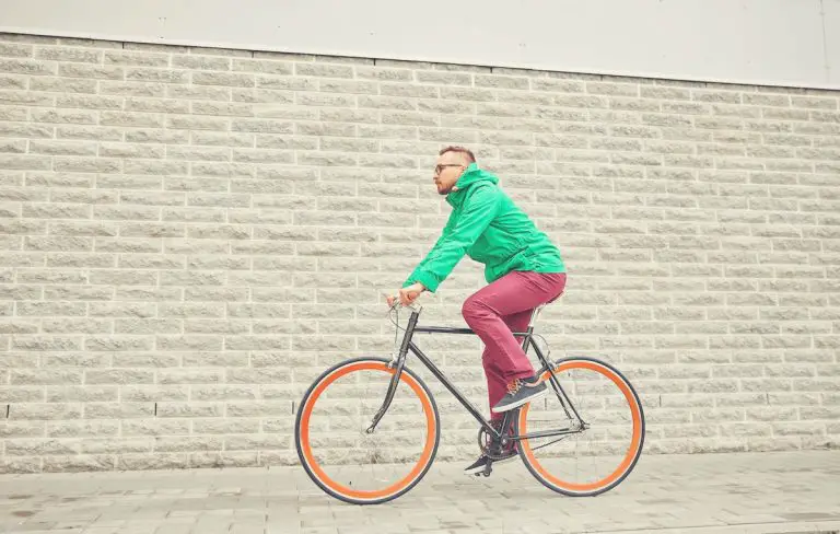 Young hipster man riding fixed gear bike