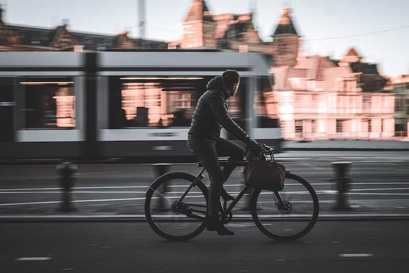 Bike Commuter Riding Along Tram