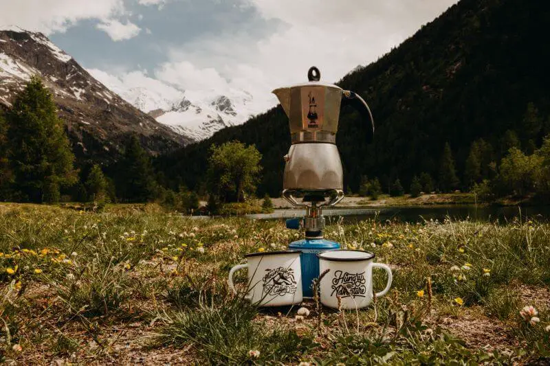 Bikepacker brewing a coffee in Switzerland