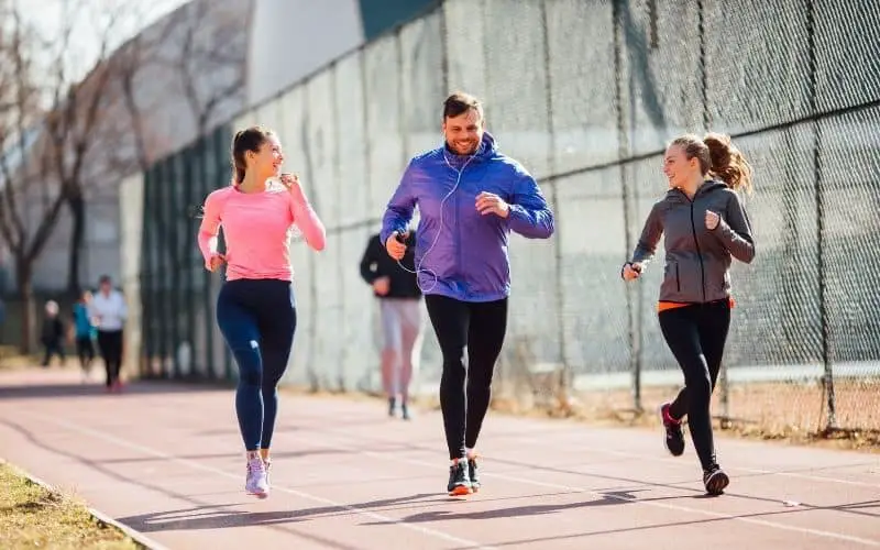 Group of runners along track laughing