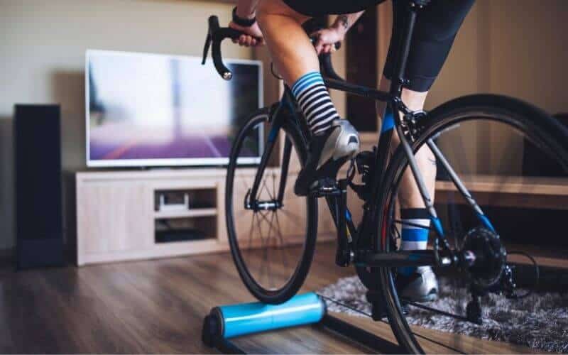 Cyclist on roller in front of TV