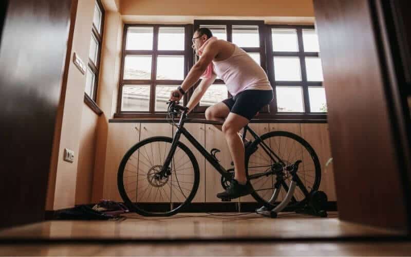 Man Wearing Pink Singlet On A Bike Trainer