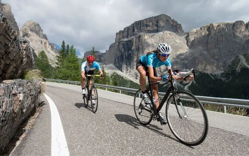 Woman and Man cycling along alps