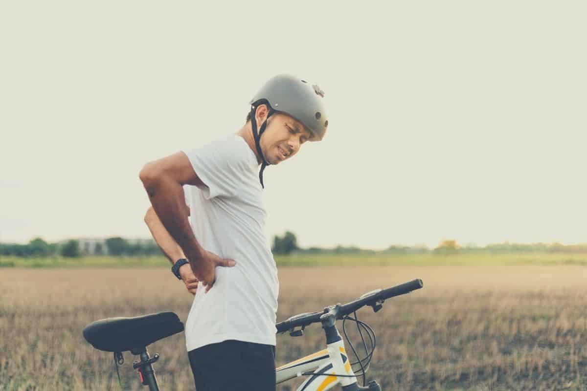 Man With Lower Back Pain Riding A Bike