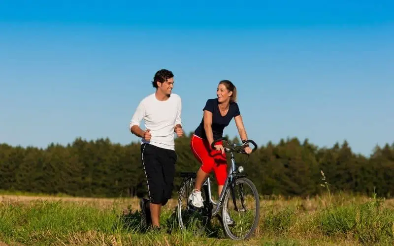Woman cycling and man running