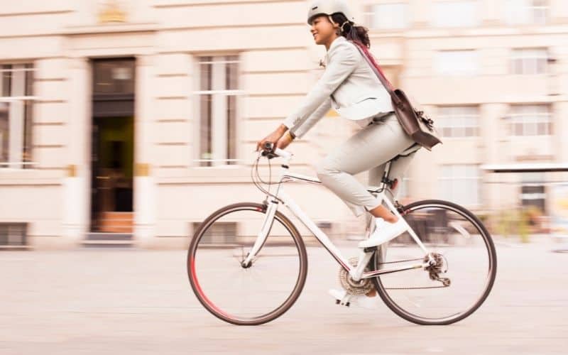 Woman cycling to work on a hybrid bike