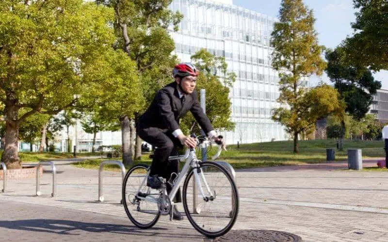 Man cycling to work in a suit