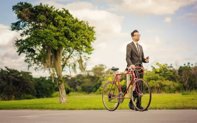 Wearing a suit and walking the road bike
