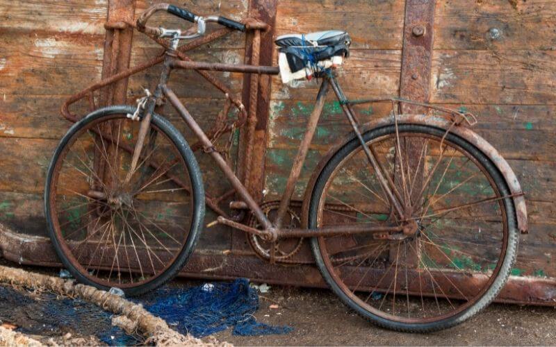 Rusted bike parked outside