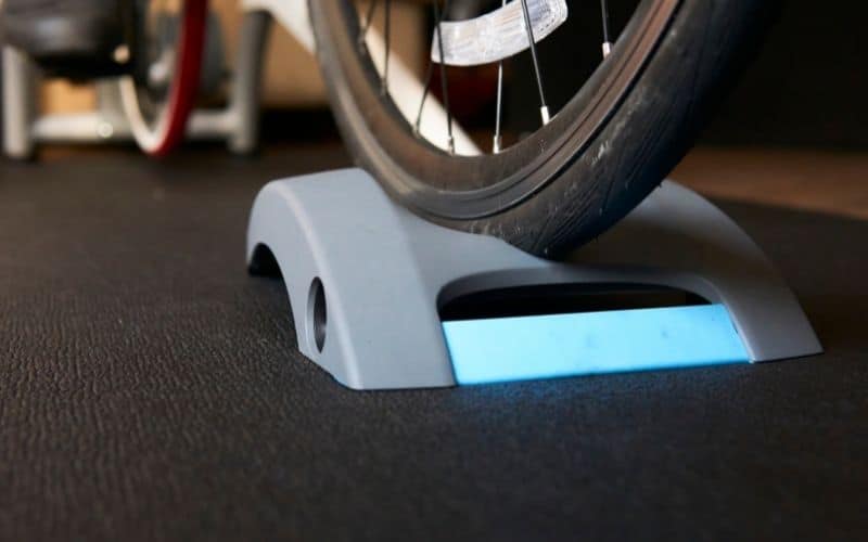 Indoor cycling setup on a black floor mat