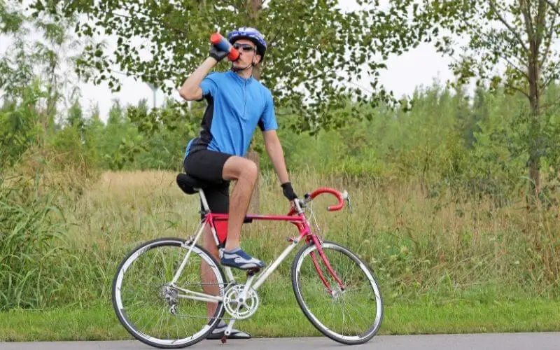 Cyclist taking a break and drinking water