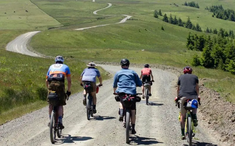 5 mountain bike riders going down a hill