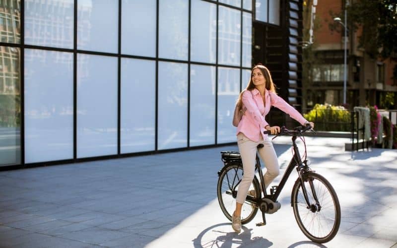 Woman riding a hybrid bicycle to work