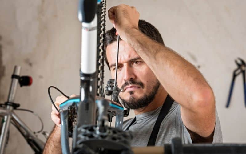 Bike mechanic cleaning and repairing bike