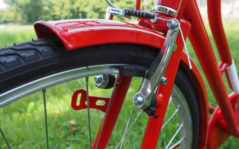 Red bike and close up of brake pad