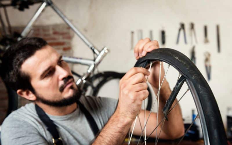 Bicycle mechanic fixing a tire