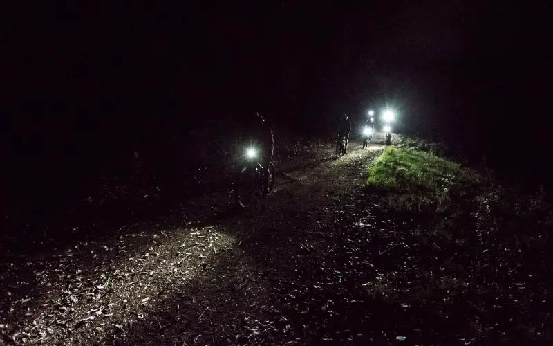Mountain bike headlights turned on during a night ride