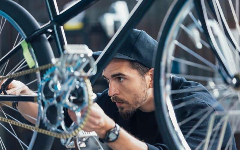 Bike mechanic looking at bike chain