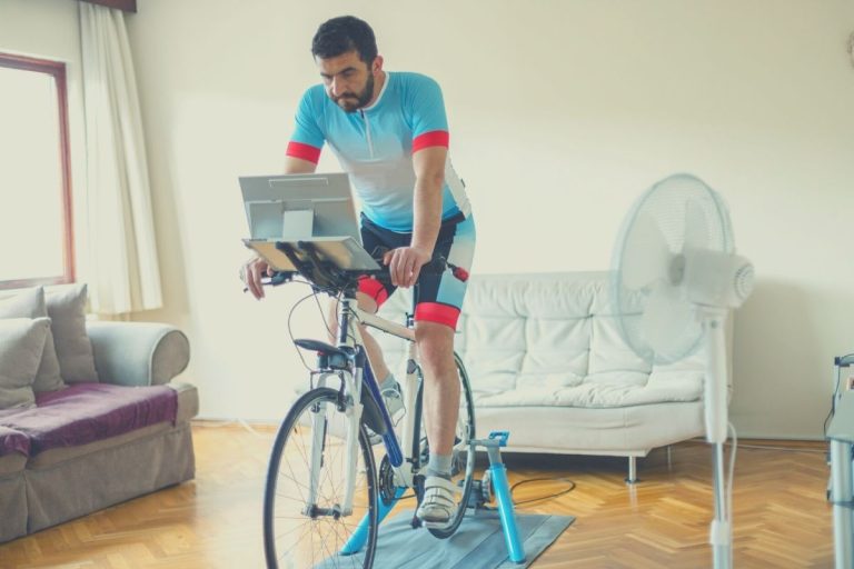 Cyclist using a fluid bike trainer in lounge room