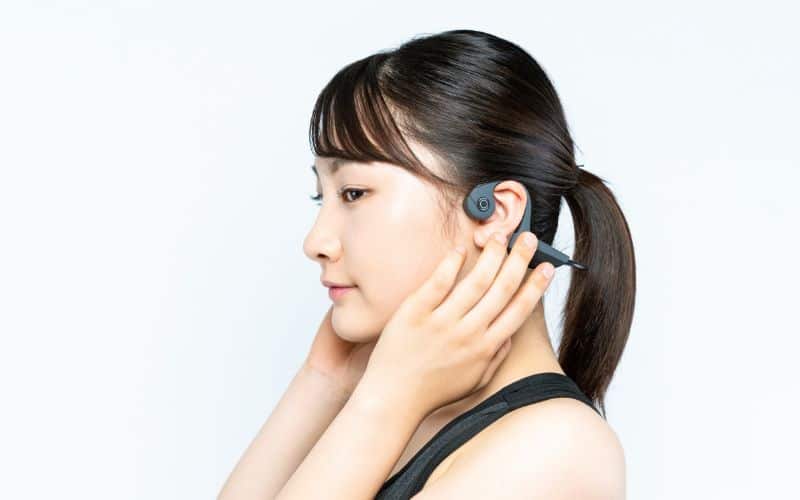 Woman wearing bone conducting headphones