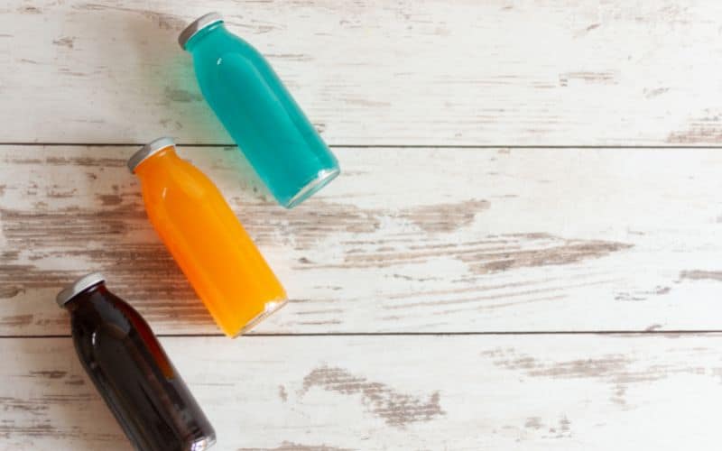 Isotonic energy drinks on wooden background