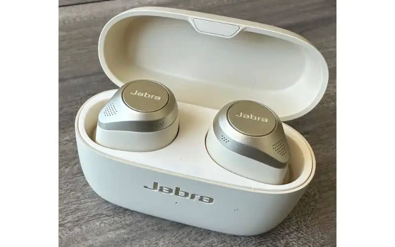 White Jabra Elite 85t headphones on grey table