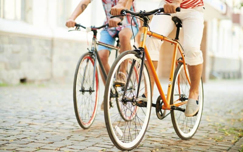 Two guys riding on steel bikes