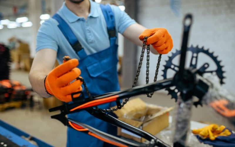 Mechanic holding a bike chain