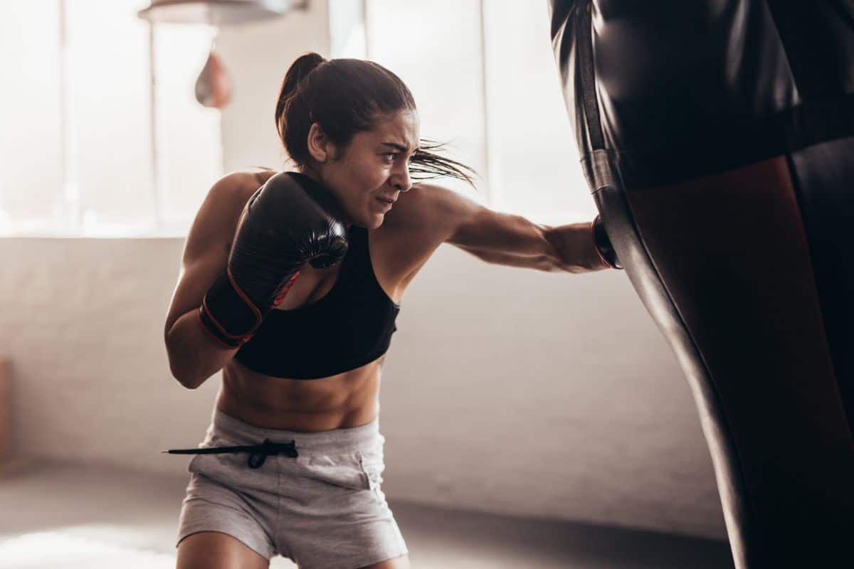 Female boxer punching a punching bag