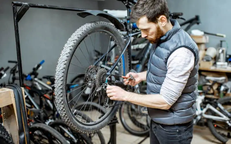 Man repairing bike in workshop