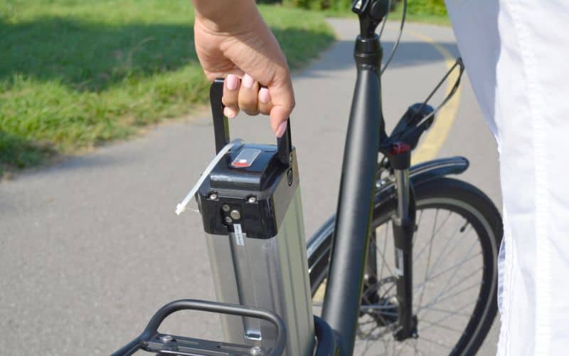 Woman installing battery in eBike