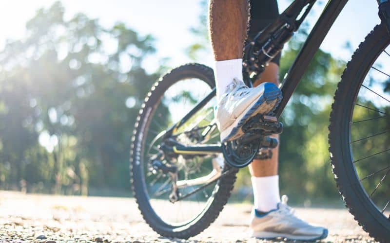 Man standing on bike pedal