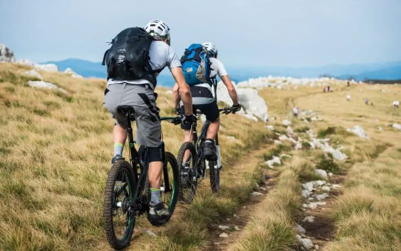 Two guys mountain biking with hiking shoes