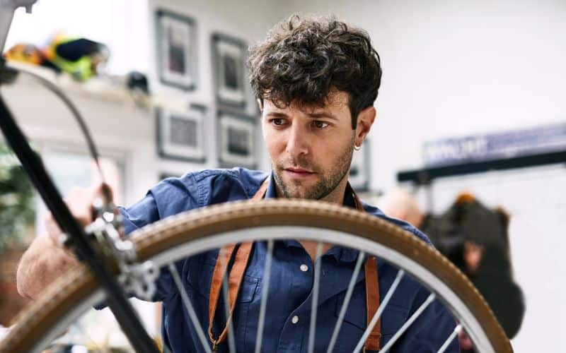 Bike mechanic repairing brakes