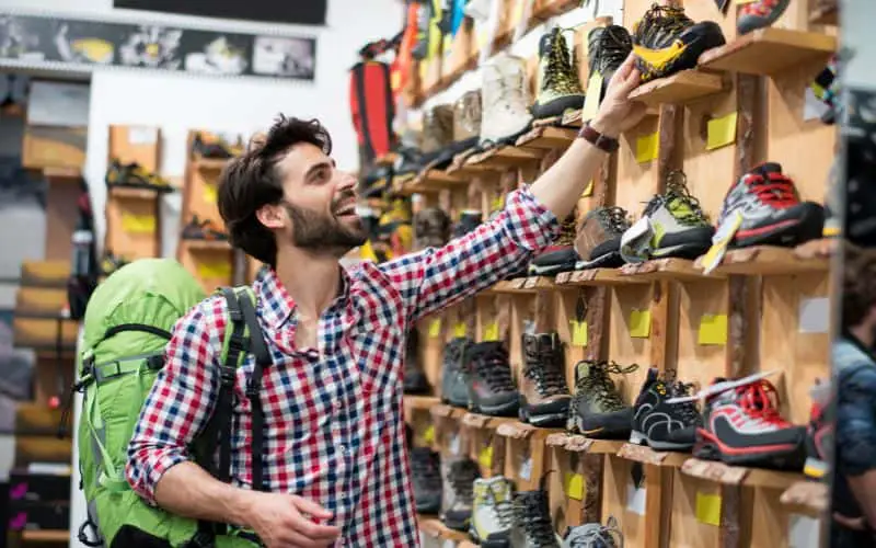 Man buying hiking shoes