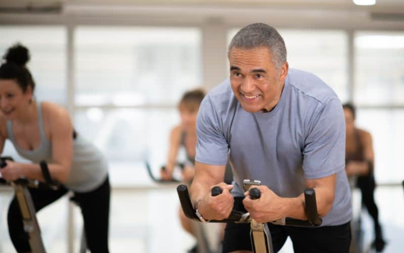 Old man indoor cycling