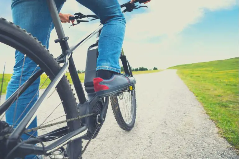 Man riding electric mountain bike up the hill