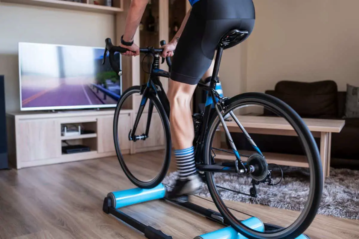 Man indoor cycling on a bike trainer