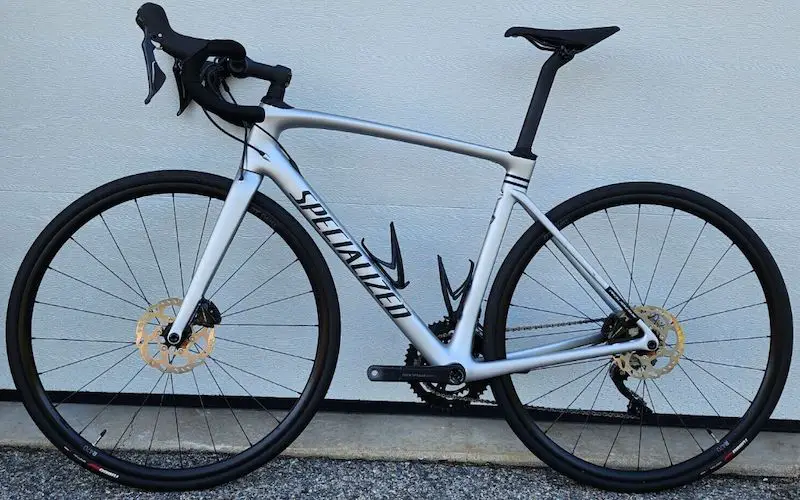 2021 Specialized Roubaix Sport leaning on a garage door