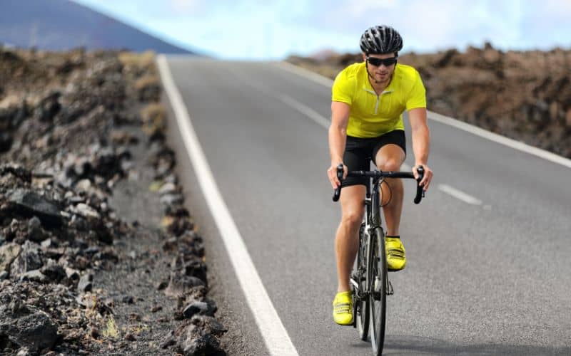 Road cyclist in bright yellow jersey
