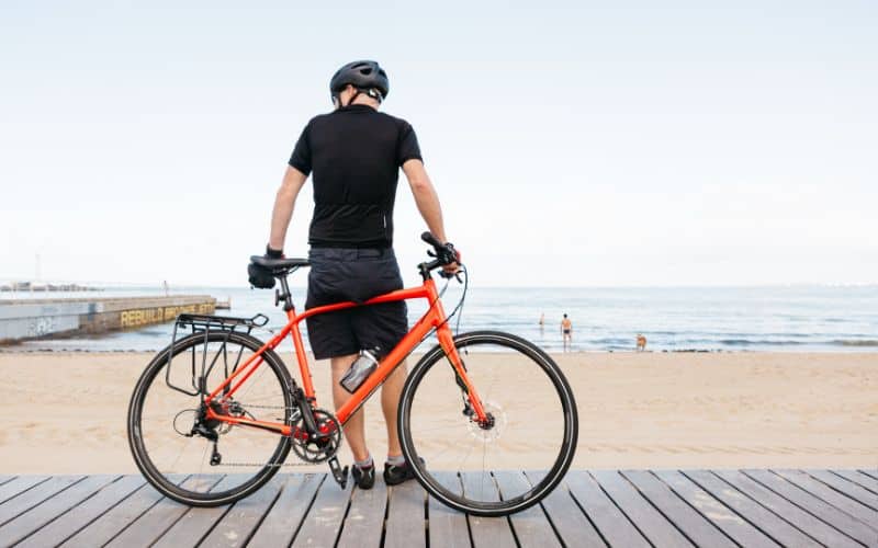 Hybrid bike rider along the beach